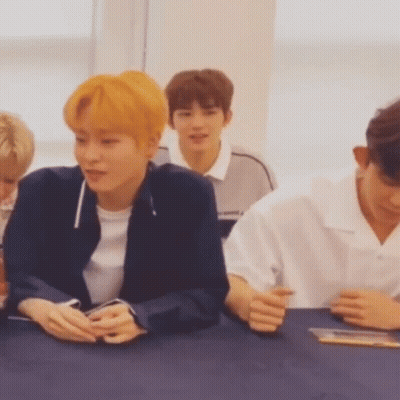 Young Men Sitting At Table With Hands Folded GIF