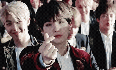 Young Men Sitting In Row Making Heart With Hand GIF