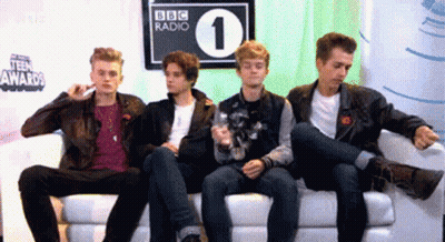 Young Men Sitting On Couch In Front Of BBC Radio 1 Sign GIF