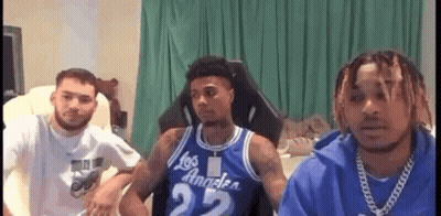 Young Men Sitting On Couch In Living Room GIF