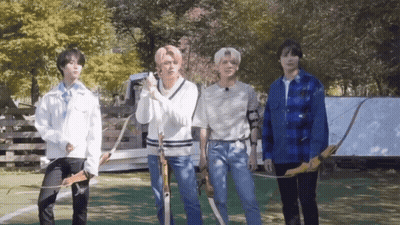 Young Men Sitting On Floor In Front Of Wall GIF
