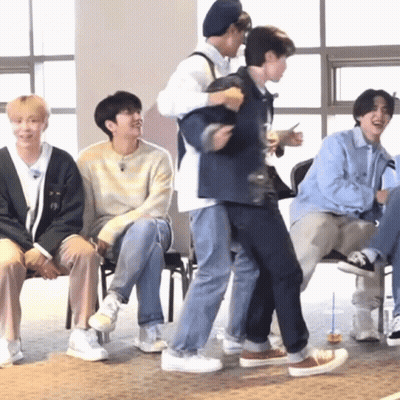 Young Men Sitting With One Carrying Another On Back GIF