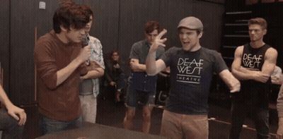 Young Men Standing Around Table With Green O'Neill Shirt GIF