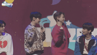 Young Men Standing In Front Of Blitzers Sign GIF