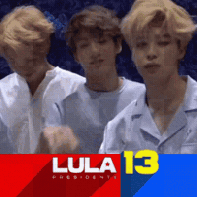 Young Men Standing In Front Of Lula 13 Banner GIF