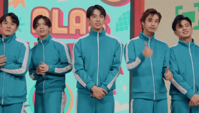 Young Men Standing In Front Of Ola Sign GIF