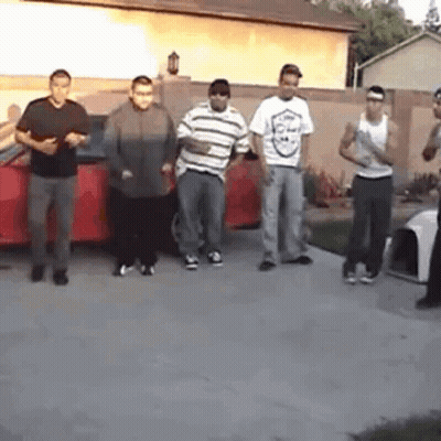 Young Men Standing In Front Of Red Car GIF