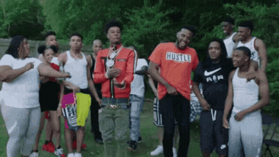 Young Men Standing In Grassy Field GIF