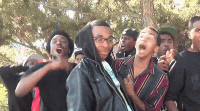 Young Men Standing In Line With Glasses And Hooded Jacket GIF