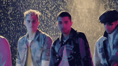 Young Men Standing In Rain With C Shirts GIF
