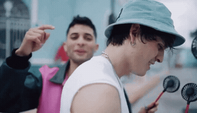 Young Men Standing In Rain With C Shirts GIF