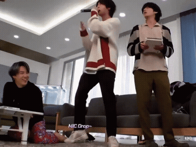 Young Men Standing Near Mic Drop Sign GIF