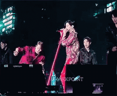 Young Men Standing On Stage With Microphones GIF