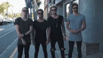 Young Men Standing Outside A & A Building GIF