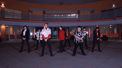 Young People Dancing In Front Of Large Building GIF