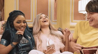 Young People Laughing At Cell Phone On Couch GIF
