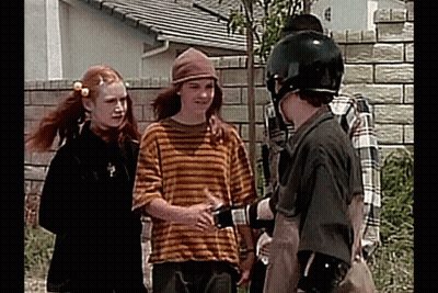 Young People Talking In Front Of Brick Wall GIF
