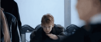 Young Red-Haired Boy Sitting At Table GIF