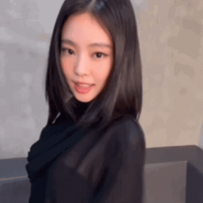 Young Woman In Black Turtleneck Looking At Camera GIF