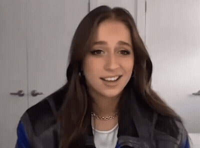 Young Woman In Blue And Black Jacket Smiling GIF