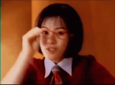 Young Woman In Glasses And Red Tie Adjusting Glasses GIF
