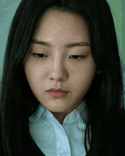 Young Woman In Green Sweater Making Heart With Hands GIF
