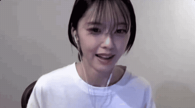 Young Woman In Headphones Sitting At Computer GIF