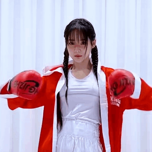 Young Woman In Red Boxing Gloves And Red Robe GIF
