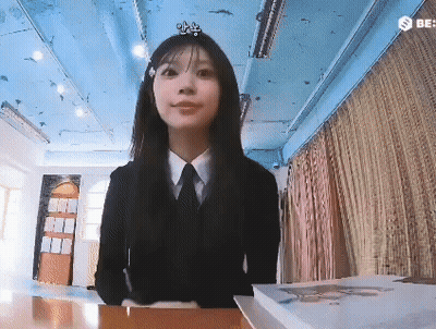 Young Woman In Suit And Tie Sitting At Table GIF