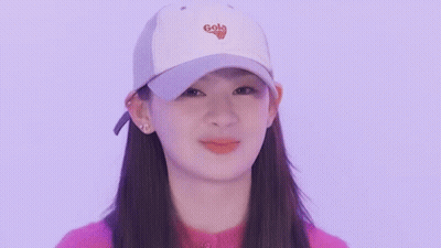 Young Woman In White Cap And Pink Sweater Making Funny Face GIF