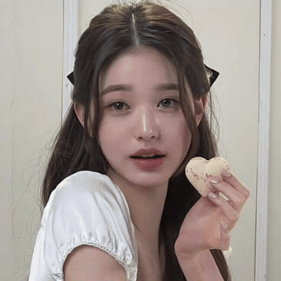 Young Woman In White Shirt Holding Heart Cookie GIF