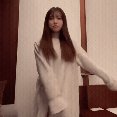 Young Woman In White Sweater Dancing GIF