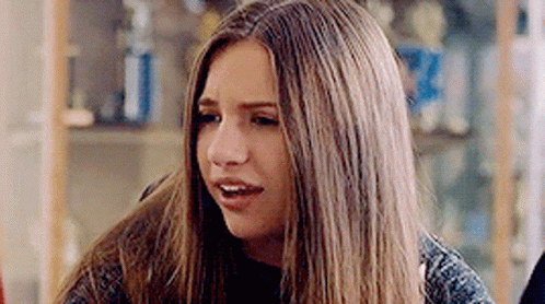 Young Woman Making Funny Face At Table GIF