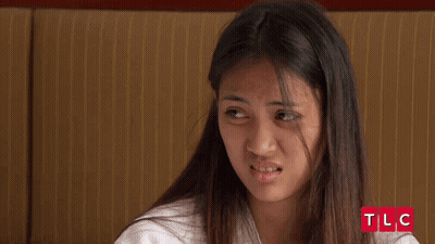 Young Woman Making Funny Face At TLC Logo GIF