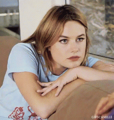 Young Woman Resting Head On Arm On Couch GIF