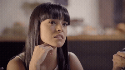 Young Woman Sitting At Table GIF