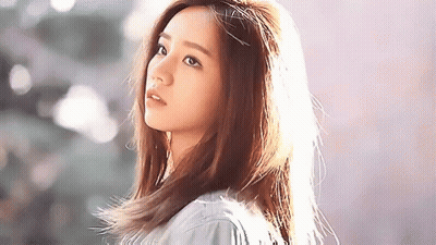 Young Woman Standing In Front Of Wall GIF