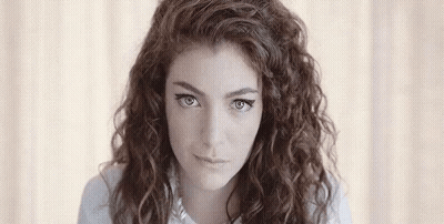 Young Woman With Curly Hair Looking at Camera