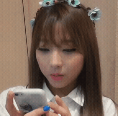 Young Woman With Flower Crown Looking At Phone GIF