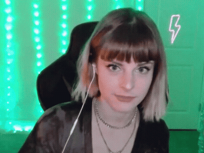 Young Woman With Headphones In Front Of Green Lightning Bolt GIF