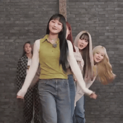 Young Women Dancing In Front Of Brick Wall GIF