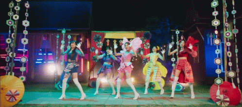 Young Women Dancing In Front Of Colorful Background GIF