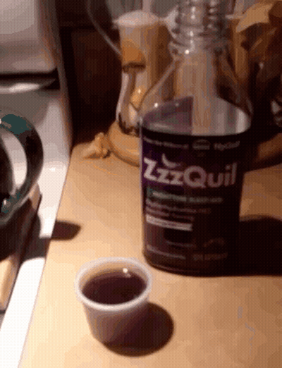 ZzzQuil Bottle Next To Cup GIF